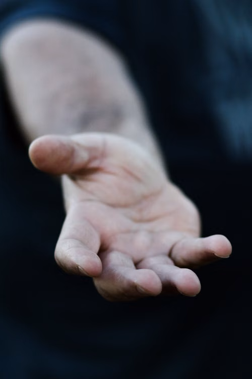 An open hand reaching out as a gesture of help and trust
