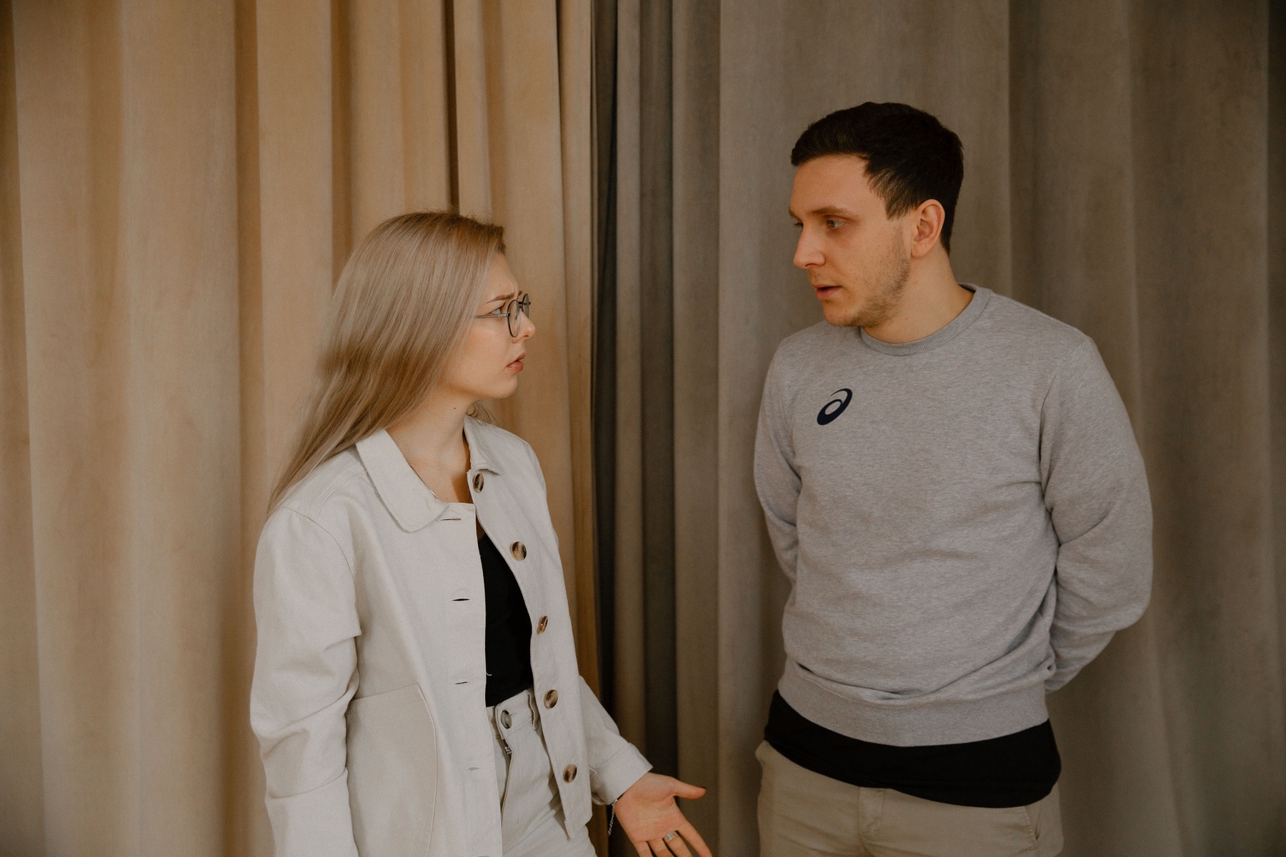 Two people having a serious conversation indoors