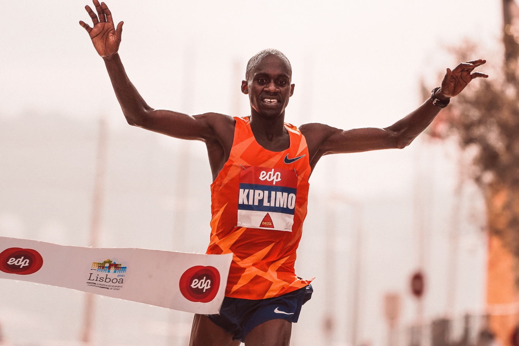 A marathon runner crossing the finish line