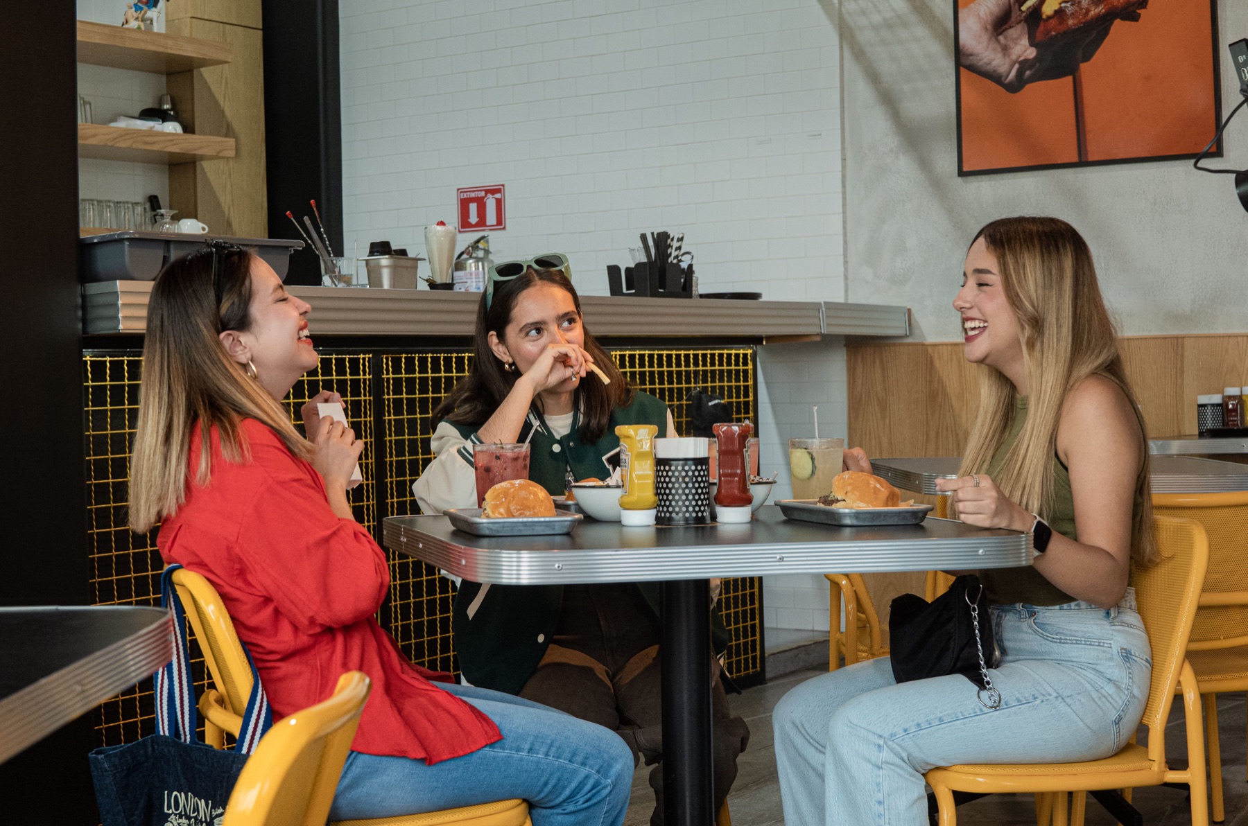Friends talking over burgers at a restaurant