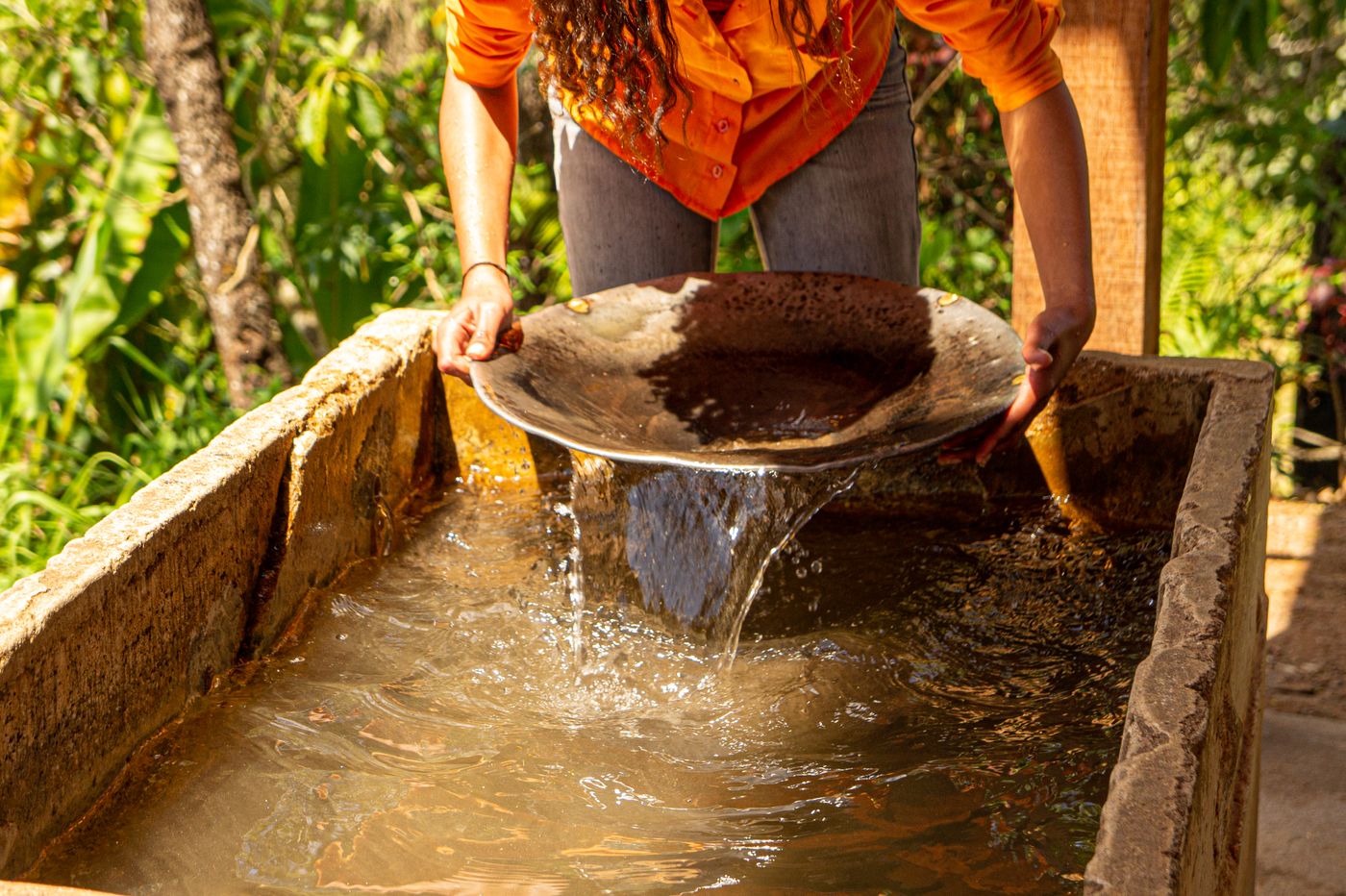 A person panning for gold in a stream