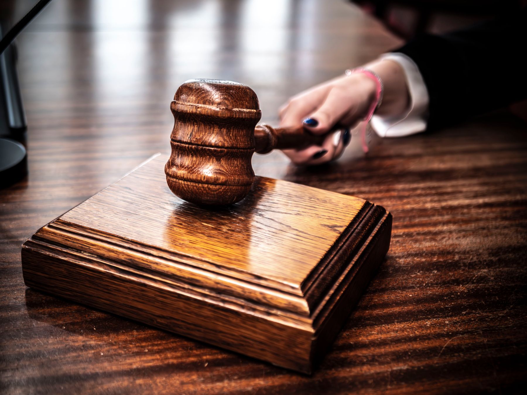 A judge’s gavel on a courtroom desk