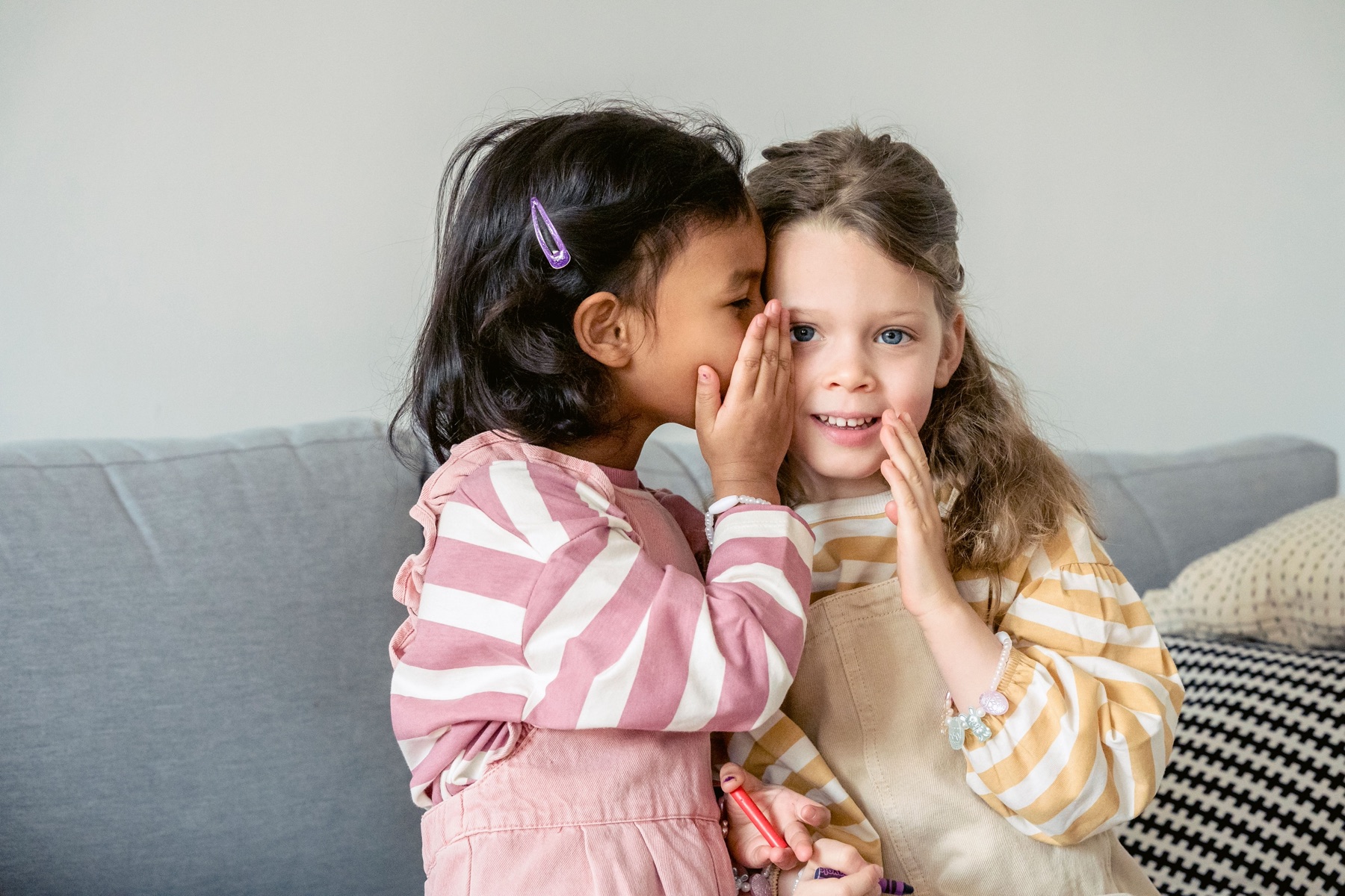 One friend quietly shares a secret with another