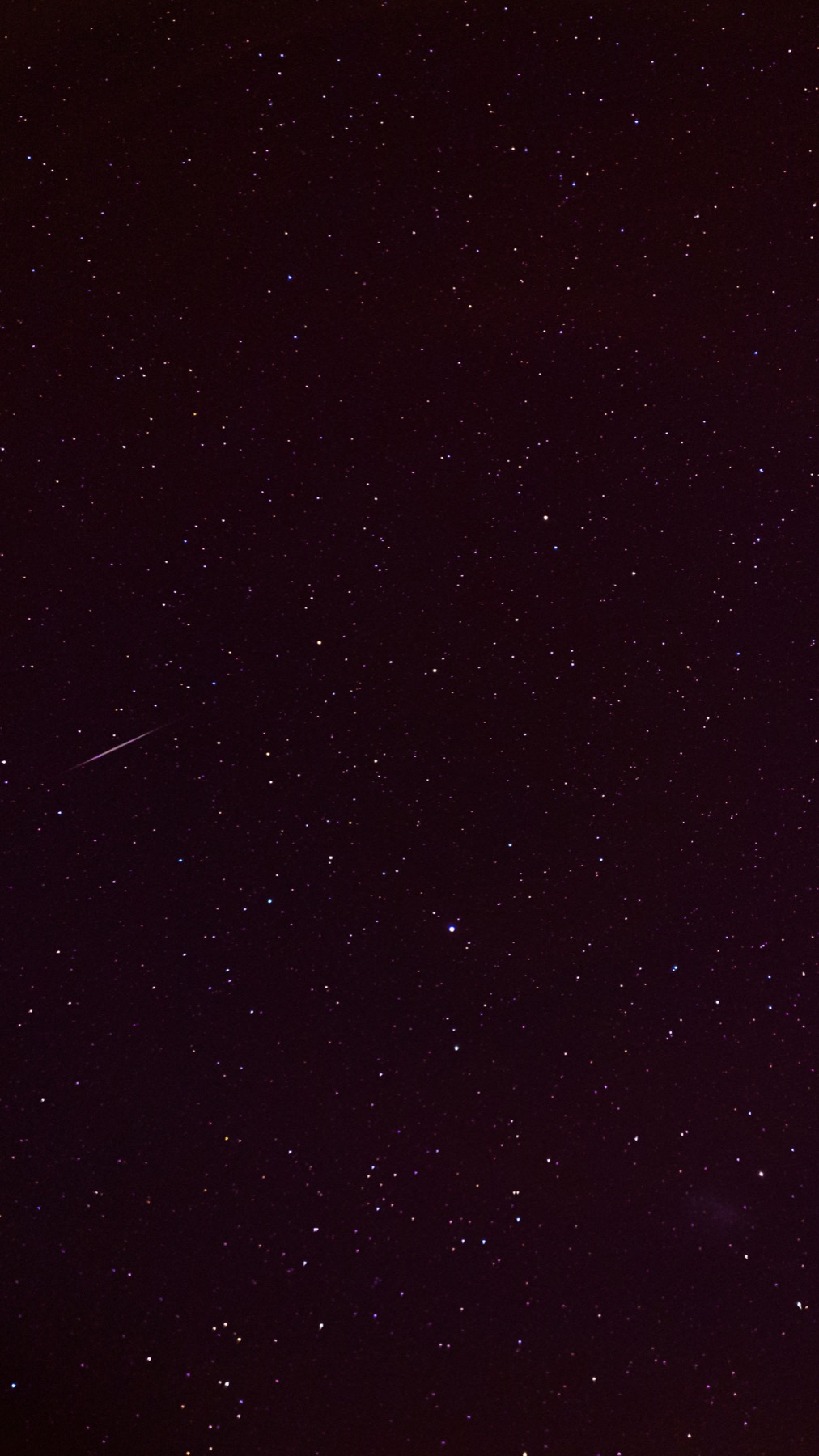 A starry night sky with a bright shooting star