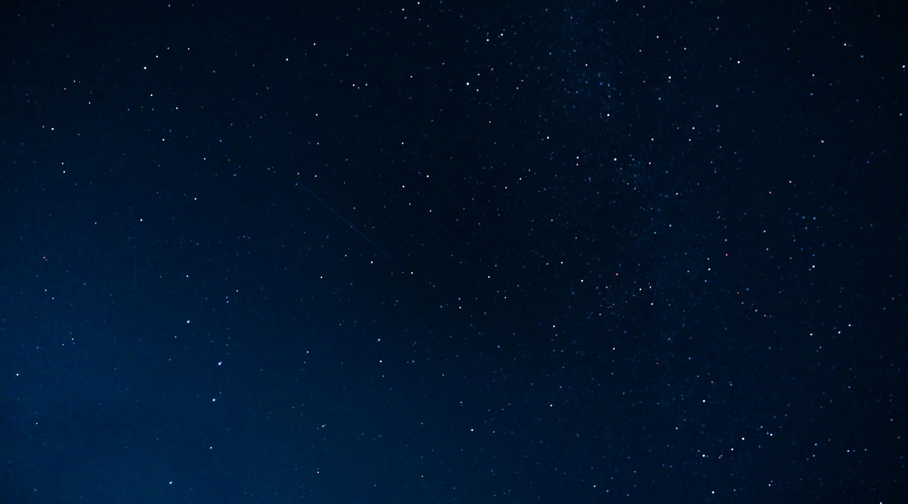 A field of stars across a deep blue night sky