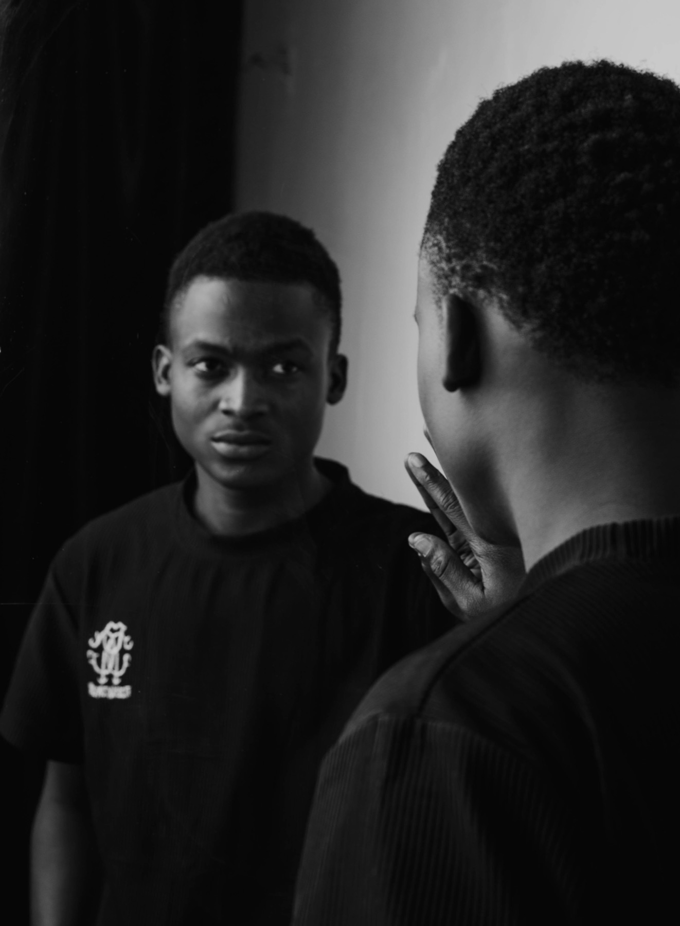 A man looking at his reflection in a mirror